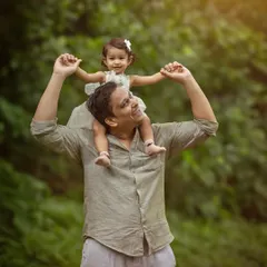The world looks different from dad's shoulders. This shot captures the special bond and playful trust between a father and his little girl during our outdoor family session.