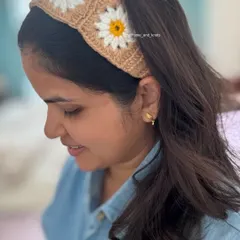 Here is my crochet daisy headband being worn. I designed it to be soft, comfortable, and add a lovely handmade touch to any outfit. The granny square design is timeless and I use 100% cotton yarn.