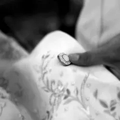 The final touches are everything. Placing a custom, jewel-encrusted button is a small but critical step in creating a garment that is truly one of a kind.