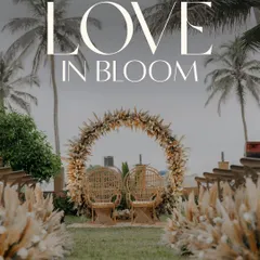 A stunning shot of a beachside wedding ceremony setup in Goa. The circular floral arch made of pampas grass against the backdrop of palm trees creates a perfect bohemian and romantic vibe.