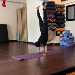 My practice extends beyond the hammock. Mat-based exercises like this handstand are crucial for developing the strength and balance that support our work in the air.