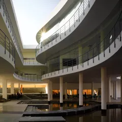The Pearl Academy in Jaipur is a testament to our climate-responsive design approach. The central courtyard, inspired by traditional Indian step-wells or 'baolis', acts as a natural thermal regulator, using evaporative cooling from the water body to create a comfortable microclimate in the desert heat.