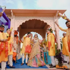 The energy of a Haldi ceremony is infectious. Here, the bride and groom make a grand entrance surrounded by their loved ones, ready for a celebration full of color and laughter.