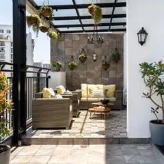 An unused penthouse balcony transformed into a luxurious Spanish-inspired outdoor lounge. With a new glass canopy, patterned tiles, and comfortable seating, this space is now a perfect urban retreat for relaxing and entertaining.