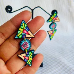 I love playing with geometric shapes. These triangular polymer clay earrings have a stained-glass effect and are assembled to create a playful, dangling look.