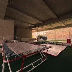 A view of the gymnastics setup, featuring trampolines and mats ready for action. This shows the professional equipment and spacious layout I provide for our gymnasts.