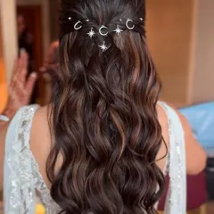 The combination of the dark, glossy waves and the sparkling silver celestial pins creates a beautiful contrast that is both elegant and eye-catching.