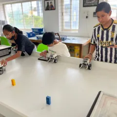 Students work together to test their line-following robots. Our training environment encourages teamwork and friendly competition to solve programming challenges.