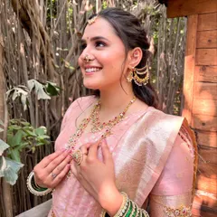 This is the radiant smile I love to see. For this beautiful Maharashtrian bride, we chose a soft, rosy makeup look to complement her pink Paithani saree. The focus was on creating a luminous, skin-like base that glowed in the natural light, making her feel absolutely unforgettable on her special day.