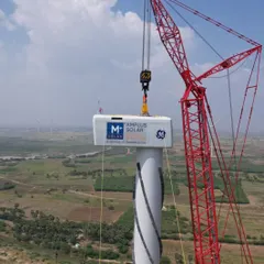 The nacelle for a wind turbine being carefully lifted into place at our Project Shiva site. We manage the complex logistics and precision engineering required to construct these large-scale hybrid projects, ensuring the highest standards of quality and safety.
