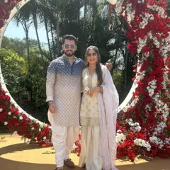 Posing with the bride and groom at their beautiful floral-decorated wedding arch. It's an honor to be a part of their special day from start to finish.