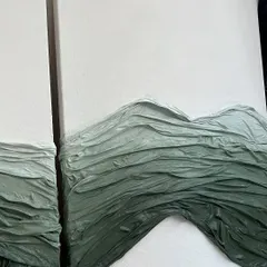 A diptych featuring waves of green fabric texture on a clean white canvas. This piece, commissioned for a Mumbai home, explores how different shades and textures can create a sense of movement and depth.