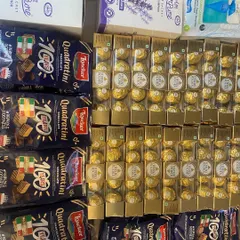 The contents for a bulk order of newborn favors. I carefully source quality treats like Ferrero Rocher and Loacker Quadratini to fill each hamper.