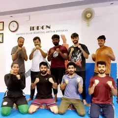 A group of our adult members after a tough weekend MMA session. The community here is strong, with everyone pushing each other to improve their striking and grappling skills.