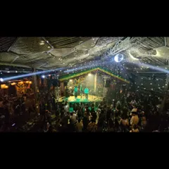 A wide shot of a packed house at The High Spirits Cafe. The disco ball, the lights, and the crowd all came together for an incredible night of live music.