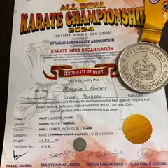 The official certificate of merit and silver medal awarded to Harshit Pandey for his performance in the senior category at the All India Karate Championship.