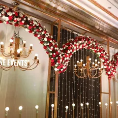 Another perspective on a grand stage design, this view shows how the flowing floral arrangements and multiple chandeliers create a sense of depth and luxury. This kind of setup is ideal for making a big impression at a corporate awards ceremony.