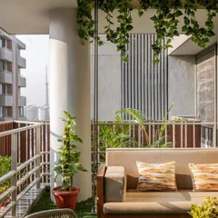 A hanging swing sofa is the ultimate statement piece for comfort and style. I integrated this cushioned swing into a modern balcony design with artificial grass flooring and a slatted privacy screen, creating a perfect nook for afternoon naps.