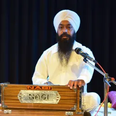 One of our instructors performing alongside students during a group Kirtan. Our faculty often performs with students to guide and support them on stage.