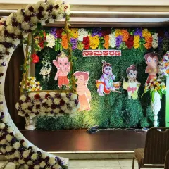 For a fun twist on a traditional naming ceremony, I can add cartoon characters like Chhota Bheem to the backdrop. This setup still includes the popular floral crescent moon swing.