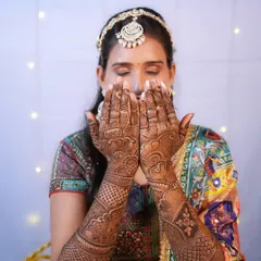 The beauty of Mehendi. This bride shows off her intricate henna design, with her makeup kept soft and subtle to let the artistry shine.