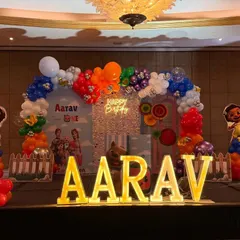 A full view of the stage setup, including the large marquee letters spelling "AARAV" which provide a fantastic photo opportunity.