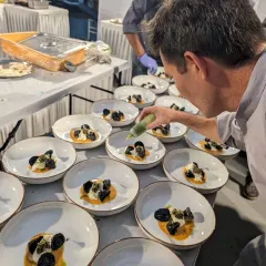 The final touch. A chef adds a drizzle of green oil to our handmade tortellini with organic sunchoke and artisanal burrata, a dish created using seasonal produce from a local organic farm.