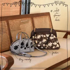 A side-by-side look at our Lace Edit on two different bags. On the left is the Tiny Mandy with black lace on a metallic Crystal leather, and on the right is the Jordan with white lace on our classic Oak brown. It shows how the same embroidery technique creates a different feel on each bag.