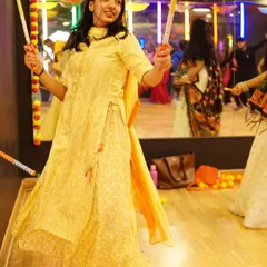 A student gracefully performs with dandiya sticks. Our workshops focus on teaching the correct form and style to make you confident on the dance floor.