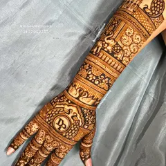 A full-arm bridal design featuring the couple's initials "DP" in a beautiful monogram on the back of the hand. The design is filled with traditional motifs like elephants, swans, and palaces.