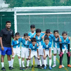 A coach with his arm around his U-11 team. We are more than just a team, we are a family.