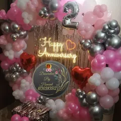 This is another example of a circular balloon backdrop, this time for a 2nd anniversary. The mix of pink and metallic silver balloons gives it a modern and celebratory feel, perfect for a party at home.