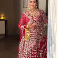 A beautiful bride in her Manish Malhotra lehenga. I created a sleek, center parted low bun and adorned it with fresh white flowers to complement her stunning outfit.