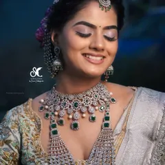 A close-up of the soft, shimmery eye makeup and the beautiful hair accessories. The hairstyle is designed to complement the heavy jewelry and ornate blouse.