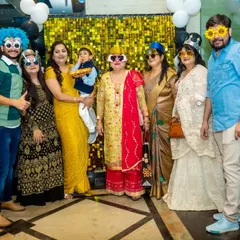 The fun isn't just for kids. Here's a whole family getting into the spirit with silly wigs and glasses in front of a shimmery photo backdrop.
