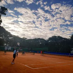 A stunning view of our green clay courts under a beautiful sky. This is where your tennis journey begins, surrounded by nature and a passion for the game.