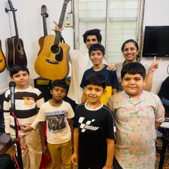 A happy group photo after a successful 'Musical Saturday'. The smiles on their faces show the joy and sense of accomplishment that comes from performing together.