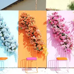 We create interactive and highly photogenic spaces. This colorful paneled wall with cascading flowers in different hues provides a fun and branded backdrop for guests to take photos at a company carnival or outdoor festival.