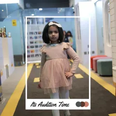 It's audition time. This young model is ready for her turn, practicing her pose in our audition space. This is the first step towards the main stage.