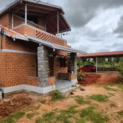 This perspective shows the main house along with the covered carport, demonstrating how we integrate practical structures into the overall design. The consistency in roofing and materials creates a cohesive property.