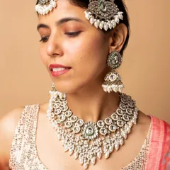 This image focuses on a different bridal set with kundan and green stones, demonstrating my ability to model a variety of traditional jewellery styles.