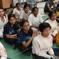 A group of our young fencers listening intently during a debrief. We create a focused learning environment where students are encouraged to absorb every piece of guidance.