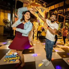 The energy at our Mucho Mambo nights is contagious. Here, two dancers are captured mid-spin, perfectly embodying the fun and freedom of social dancing.