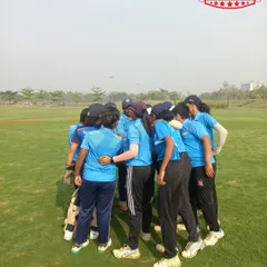 A team huddle before the game. We foster a strong sense of teamwork and camaraderie in our girls' squad.