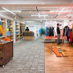 For Capsul in Mumbai, we transformed a former bank into a gritty, adaptive retail environment. The design uses raw materials like concrete pavers and wood, creating distinct zones that encourage exploration, while a custom lighting grid sets a dynamic, urban mood.
