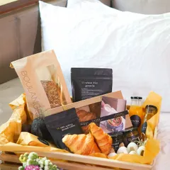 Our luxurious breakfast-in-bed hamper, designed to make any morning special. This beautiful wooden crate is filled with fresh croissants, our wheat-free granola, artisanal coffee, fresh juice, and other gourmet treats.