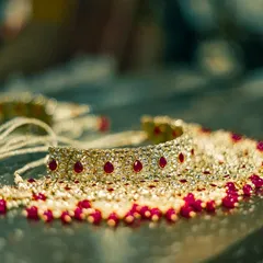 A close-up shot of an elegant bridal necklace with ruby and pearl details. We take care to capture the intricate craftsmanship of your wedding jewelry, as it is a key part of your bridal attire.