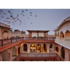 A flock of pigeons takes flight over the restored Haveli Dharampura, a sight common in Old Delhi. The design of the terrace provides guests with an authentic connection to the life and traditions of Chandni Chowk.