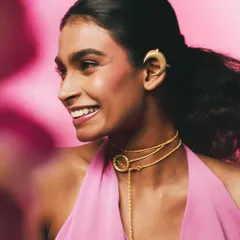 A joyful, smiling portrait from the Batoki.art campaign. This image captures a different mood, showing how the jewelry can be part of an expressive, happy moment, making the brand feel relatable and warm.