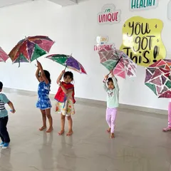Look at the pride and joy on their faces! Holding up their finished, hand-painted umbrellas is the best part of the workshop. The colorful results speak for themselves.